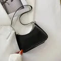 Minimalist black glossy crescent underarm bag with silver zipper and sleek PU finish - Black