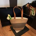 Beige woven straw bucket bag featuring black horizontal stripes and brown leather handles - Horizontal Striped Style (No Scarf)