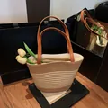 Two-tone woven straw bucket bag with brown leather handles and a secure zipper closure - Color Block Woven Style (No Scarf)