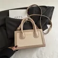 Beige accordion crossbody bag in stitched faux leather and canvas with top handles - Khaki
