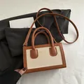 Chic vintage beige canvas and brown leather crossbody bag with top handle and gold logo - Brown