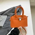 Chique oranje schelpvormige handtas met litchi-textuur en zilveren metalen slotje - Oranje