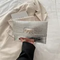 Silver envelope clutch bag with crocodile embossing and a golden bow metal buckle - Silver