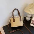 Straw woven handbag in beige with brown leather handles and adjustable shoulder strap - Brown
