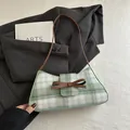 Green and white plaid underarm bag with a brown leather bow and slim shoulder strap - Green