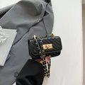 Mini black quilted chain bag with V-shaped stitching and golden turn-lock closure - Black