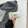 White quilted mini crossbody bag with chevron pattern and gold-tone twist-lock closure - White