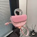 Pink saddle crossbody bag with textured patchwork and unique irregular metal handle - Pink