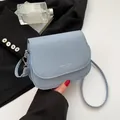 Light blue textured saddle bag with silver hardware and adjustable shoulder strap - Blue