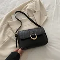 Elegant black woven texture shoulder bag with gold U-shaped buckle for daily commute - Black
