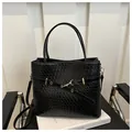 Large black woven bucket tote bag with gold buckle detail and detachable shoulder strap - Black