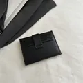 Slim black multi-slot card holder in premium textured faux leather with minimalist strap - Black