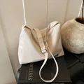 Chic beige glossy leather underarm tote bag with adjustable shoulder strap and gold plate - White