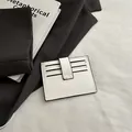 Minimalist white faux leather card holder with 6 slots and button strap closure - White