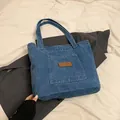 Blue denim tote bag with spacious compartment and vintage brown faux leather patch detail - Light Blue