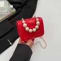 Chic red mini shoulder bag with heart embossing and white pearl handle strap - Red