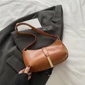 Minimalist caramel brown PU leather crescent shoulder bag with golden metal buckle - Brown