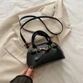 Classic black Boston bag with gold horsebit buckle on beige blazer background - Black