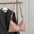 Chic pink crescent shoulder bag with knotted strap detail and metallic zipper closure - Pink