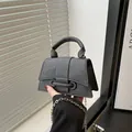 Minimalist grey trapezoid handbag with matte texture and silver chain strap - Black