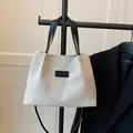 Minimalist beige canvas tote bag with black handles and fashion label for daily use - Beige And Black (Without Pendant)