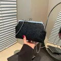 Elegante borsa da sera con paillettes nere, telaio argento e tracolla a catena - Nero