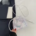 White sequin drawstring bucket bag with iridescent finish for fashion crossbody wear - White