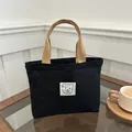 Mini sac en toile noire avec poignées marron et motif ours minimaliste sur patch - Noir