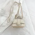Chic cream-colored mini crossbody bag with textured leather and gold-toned ring buckle - White