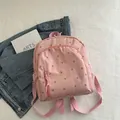 Mini pink floral backpack with adjustable straps and front pocket for casual use - Pink