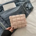 Pink quilted bubble texture makeup bag shown against denim background in a stylish view - Pink