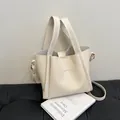 Beige litchi grain leather bucket bag with golden Fashion logo and detachable strap - White