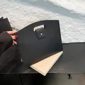 Minimalist black pebble leather commuter tote bag with magnetic snap and cutout handle - Black