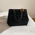 Black canvas tote bag with white contrast stitching and a large front pocket for women - Black