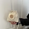 Cream straw woven drawstring bucket bag with large daisy flower ornament for summer - White and White