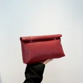 Deep red woven leather clutch bag featuring a rectangular flap and intricate pattern - Red