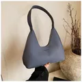 Detailed close-up of blue-grey woven texture tote bag with embossed fashion text - Blue