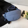 Minimalist blue nylon crescent chest bag with adjustable wide strap and woven zippers - Blue