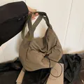 Large khaki pleated crossbody bag with wide olive green shoulder strap for daily commute - Green