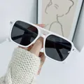 Close-up of square white sunglasses with dark lenses and silver metal corner details - White Frame Dark Grey Lens
