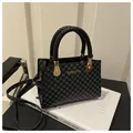 Borsa tote con stampa geometrica nera e grigia, manici intrecciati e logo dorato - Nero