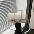 White embossed floral crossbody bag with gold hardware and top handle for women - White