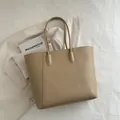 Minimalist khaki leather tote bag with long straps and stylish lettering - Khaki