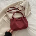 Vintage burgundy suede bucket bag with dual ring handles and adjustable shoulder strap - Red