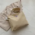 Chic beige corduroy tote bag with vertical texture and Fashion Instinct label - Khaki