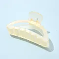 Close-up of a matte cream yellow shark hair claw clip showing textured grip and spring - Semi-circular Yellow