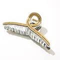 Detail of a large hair claw clip with acetate finish and sparkling rhinestone accents - Gold