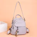 Zaino elegante in pelle lilla a grana litchi con grazioso ciondolo a forma di mucca - Viola
