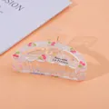 Detailed view of clear acrylic hair claw clip with pink cherry print and French text - Cherry