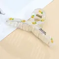 Detail of transparent acrylic hair claw with pineapple print and golden metal spring - Pineapple / Standard